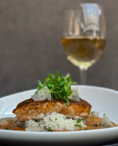 An entrée of Texas Redfish with Court-Bouillon, Ritz Creole, and Green Tomato