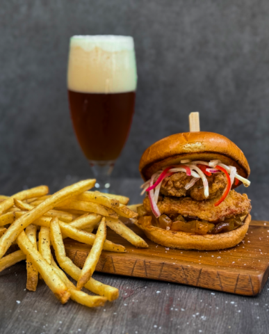 A curry fried chicken sandwich with sweet mango relish, and celery root slaw