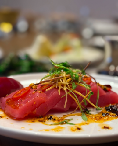 A Dish of Tuna Crudo with Salsa Macha, Fresno Chiles, Carrot, Lime